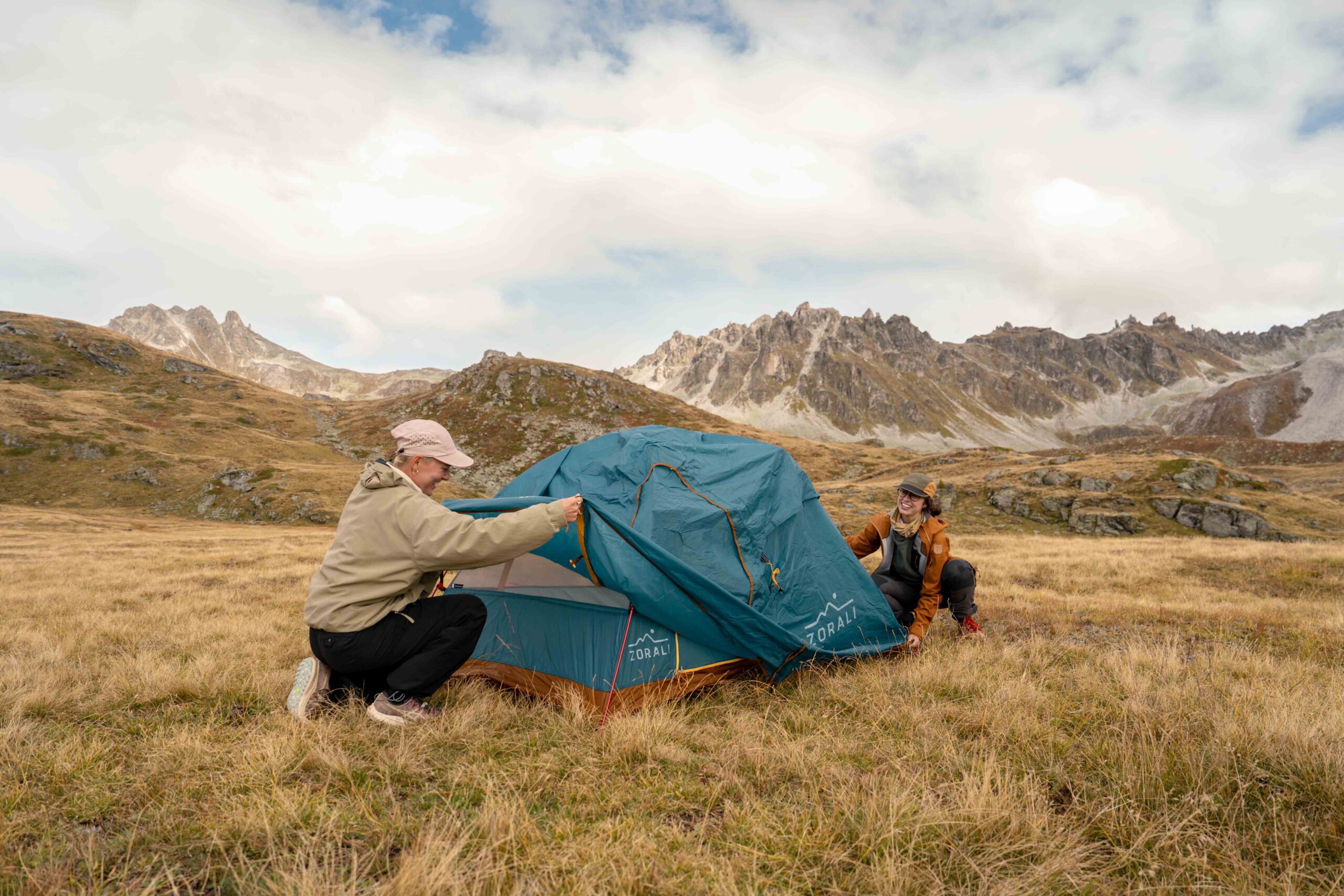 Photography of people setting up a zorali tent